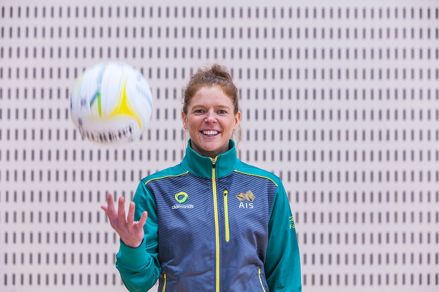 Diamonds shooter Tegan Philip throws a netball in the air.