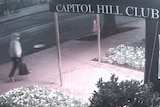 Security footage shows a person wearing a grey hoodie and carrying a backpack walking past the Capitol Hill Club