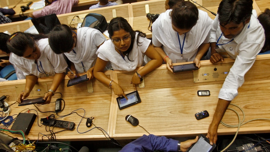 Students use Aakash, dubbed the world's cheapest tablet computer, after its launching ceremony in New Delhi.