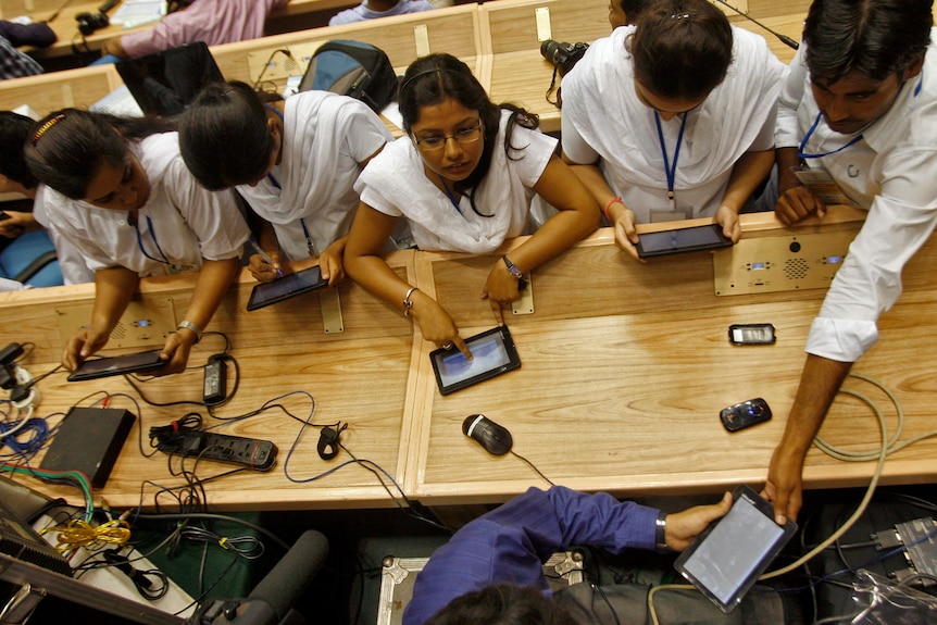 Students use Aakash, dubbed the world's cheapest tablet computer, after its launching ceremony in New Delhi.