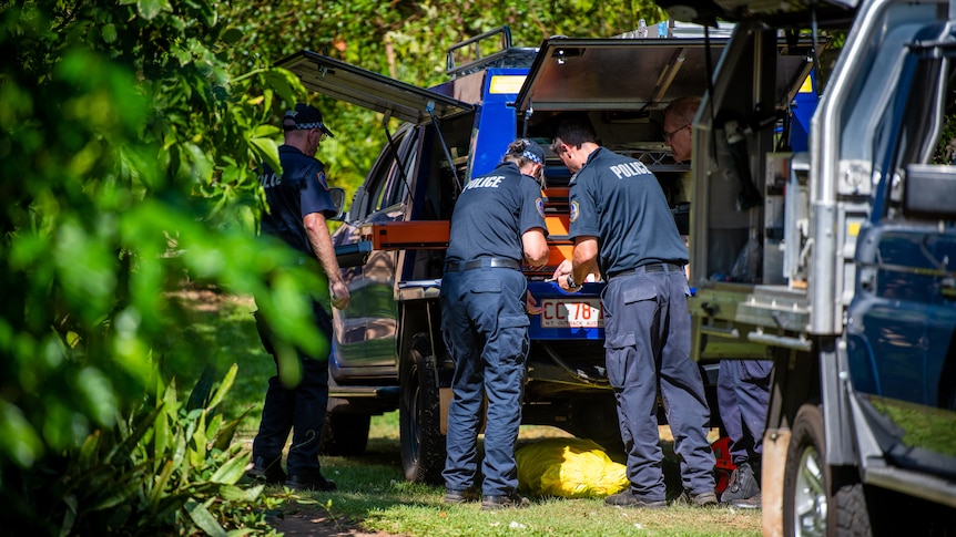 NT Police search their car at a crime scene in Darwin's Northern suburbs. 