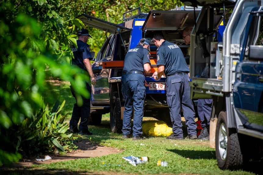 NT Police search their car at a crime scene in Darwin's Northern suburbs. 