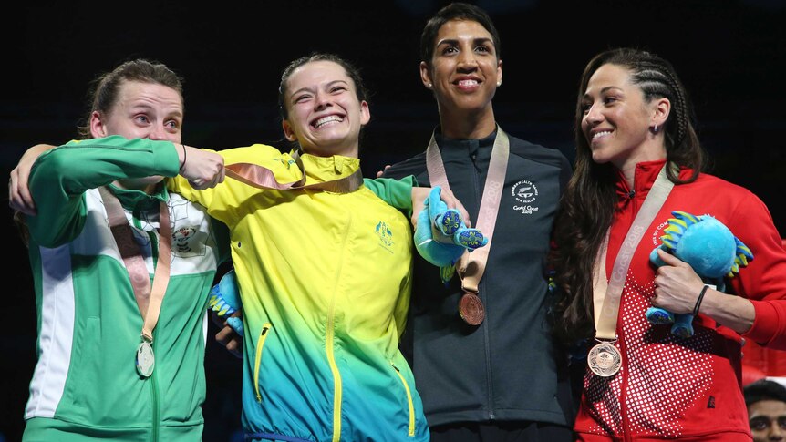 Silver medallist Michaela Walsh (L) and gold medallist Skye Nicolson (2L) after women's 57kg boxing.