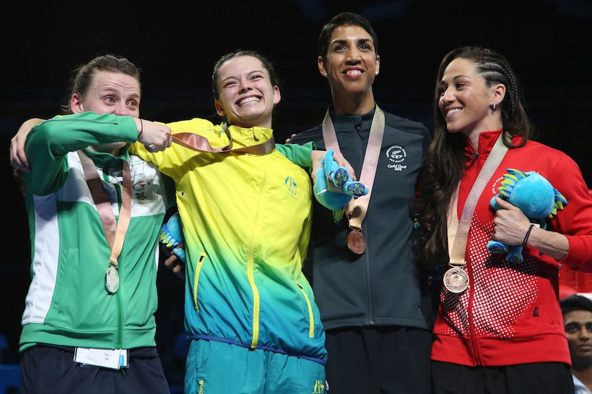 Silver medallist Michaela Walsh (L) and gold medallist Skye Nicolson (2L) after women's 57kg boxing.