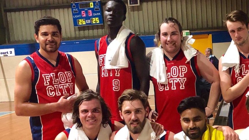 Richard Allan and other teammates pose for a photo.