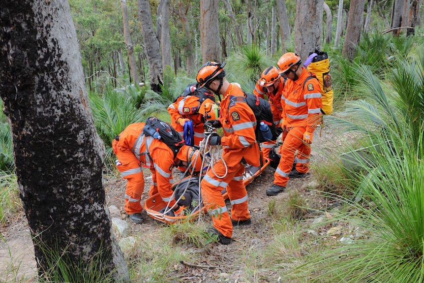 SES crew in bushland 'rescuing' a dummy on a sled