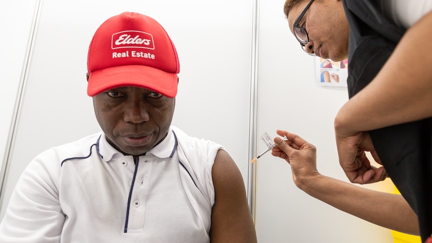 A man of African decent getting the COVID vaccine.