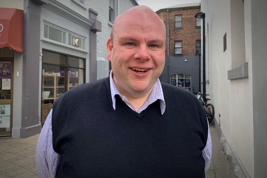 Portrait of a bald man smiling at the camera