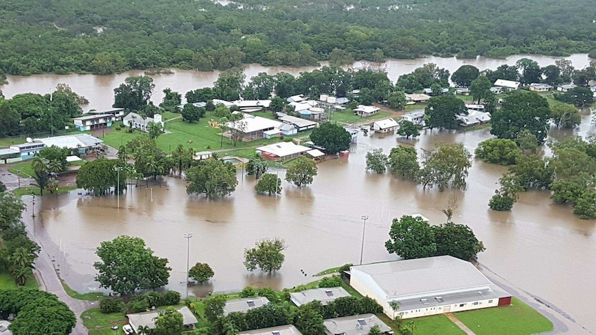 Some homes under water as others are surrounding by flood waters near Daly River.