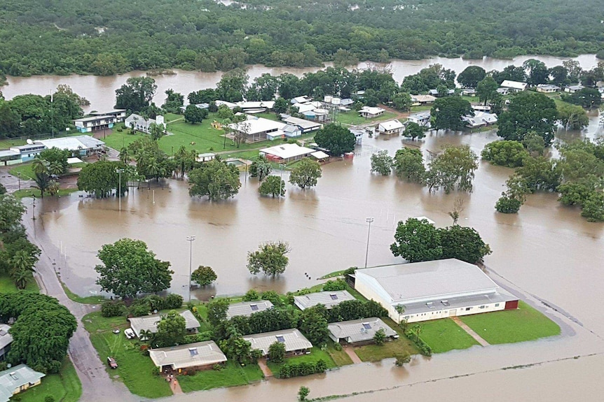 Some homes under water as others are surrounding by flood waters near Daly River.