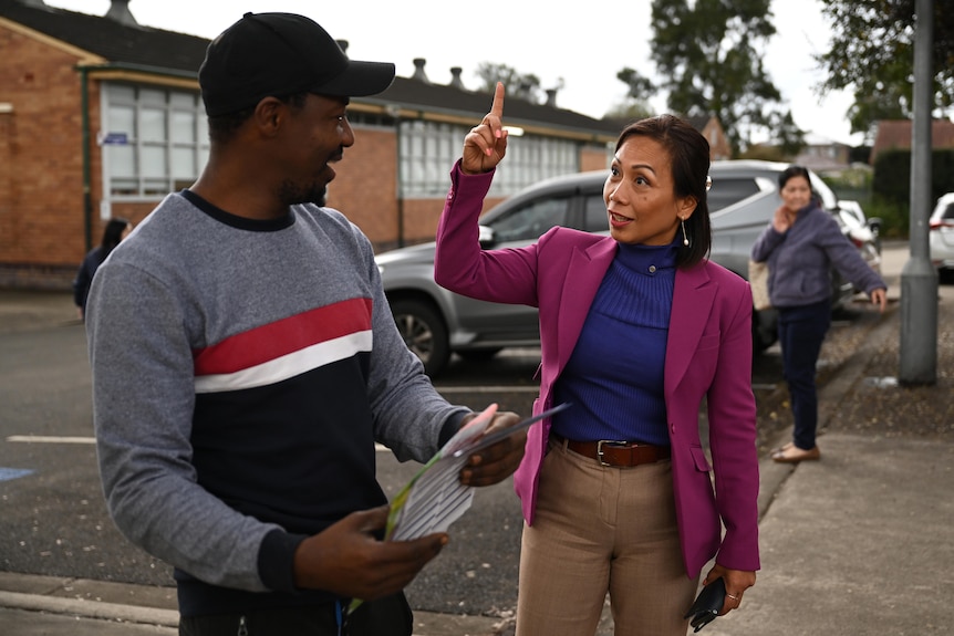 a woman talking to another man