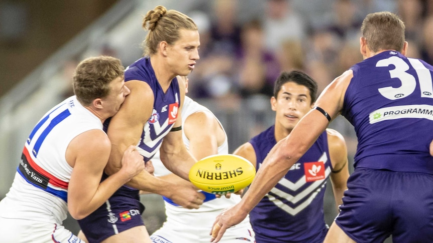 Fremantle captain Nat Fyfe handballs