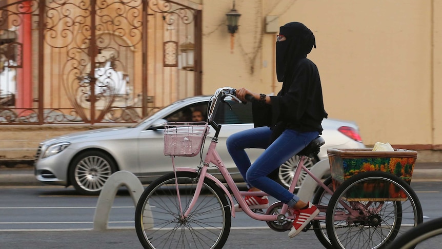 A Saudi woman rides her pink bicycle in Saudi Arabia