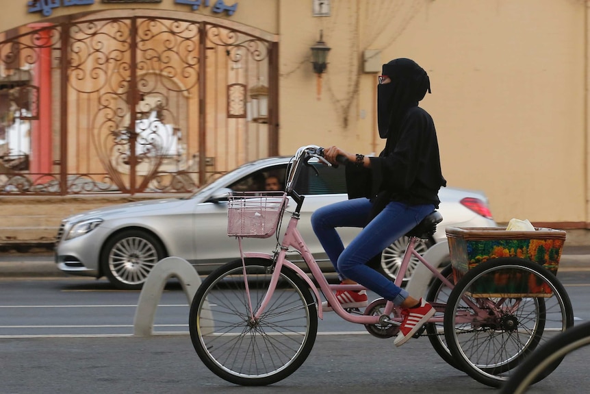 A Saudi woman rides her pink bicycle in Saudi Arabia