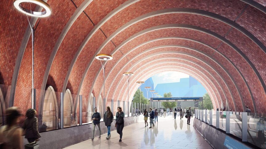 An artist impression of the concourse at the new North Melbourne Station, with brick archway over a pedestrian concourse.