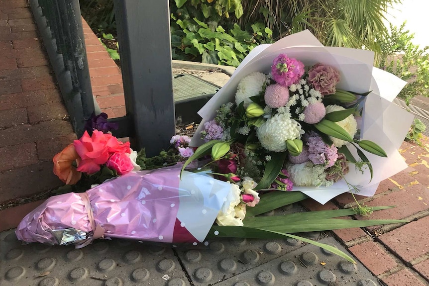 Flowers at the scene of a woman's death at Colonnades