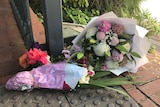 Flowers at the scene of a woman's death at Colonnades