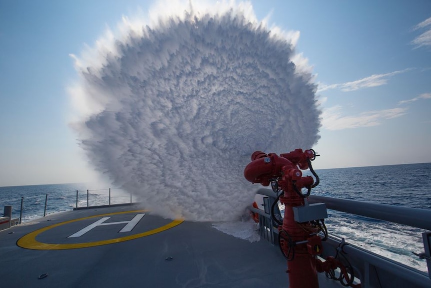 Water cannon firing from Ocean Warrior