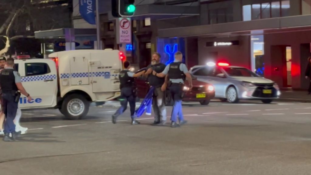 Man being escorted by police