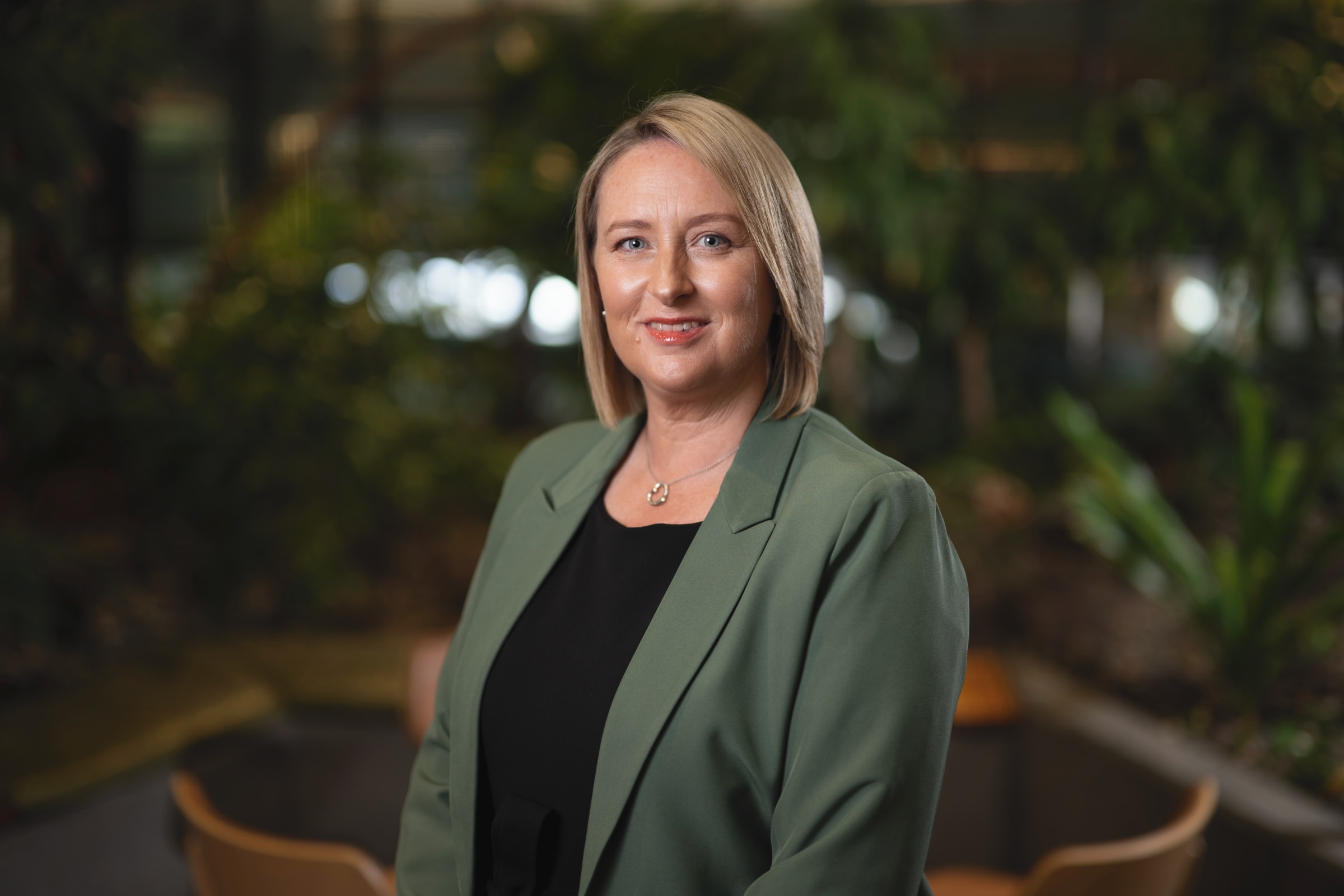 Professor Amanda Kennedy stands in a green jacket.