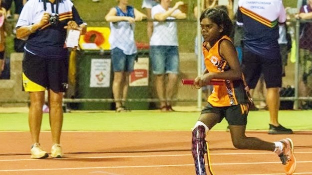 One legged girl running on athletics track