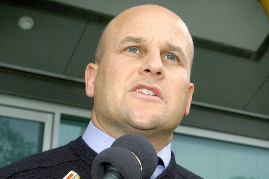 A rugby union administrator speaks to the media in Canberra in 2004.