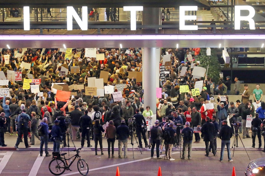 People swarm outside the international terminal at LAX