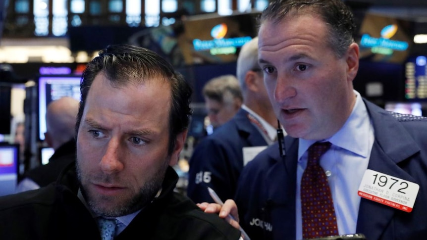 Traders work on the floor of the New York Stock Exchange.