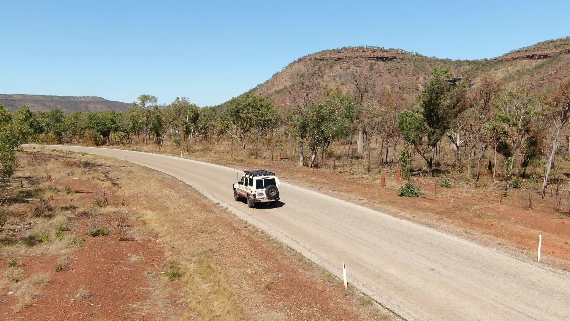 A drone shot of Timber Creek with a car seen driving along a highway.
