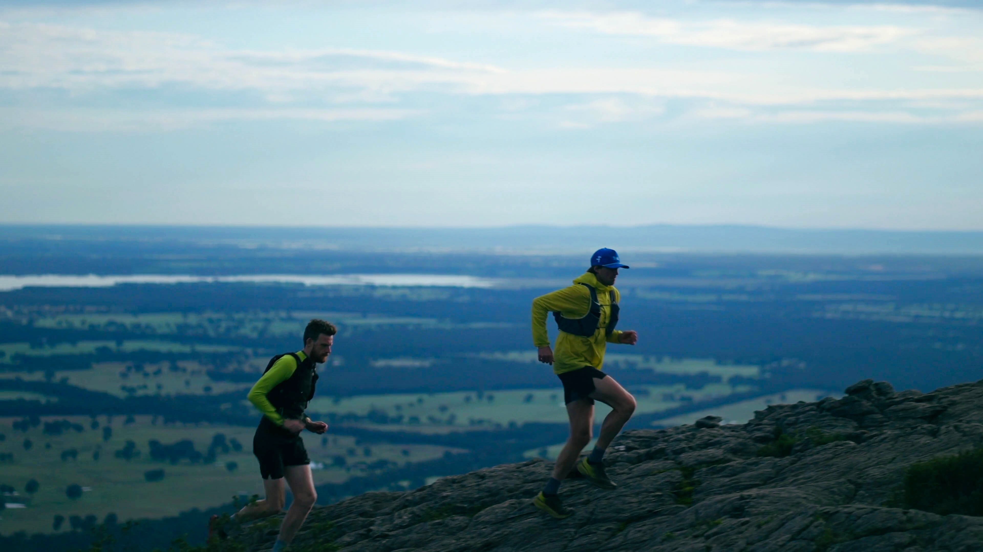 two runners on the top of a mountain ridge in regional victoria
