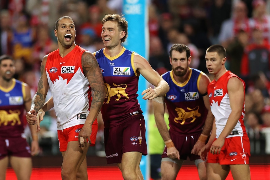 Harris Andrews and Lance Franklin smile and bump into each other