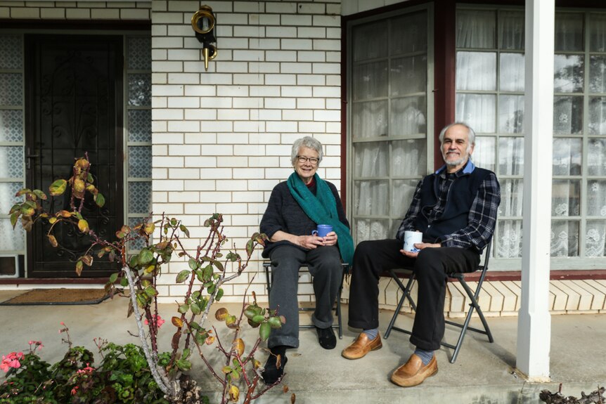 Julia and Joe Scoglio drinking tea on their front verandah.