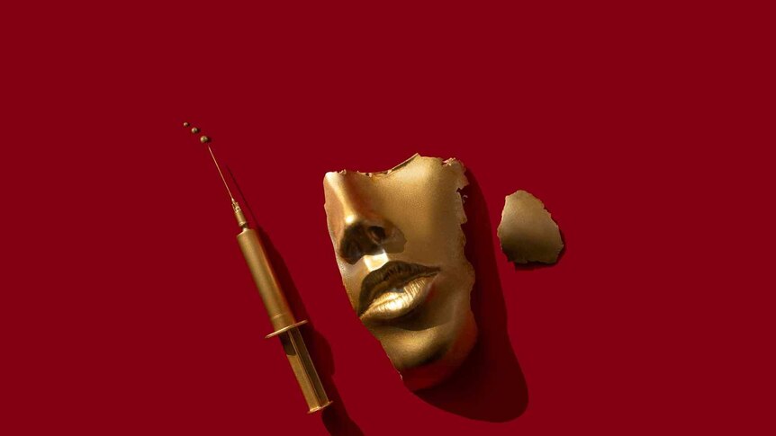 A fragment of a face and a syringe in gold
