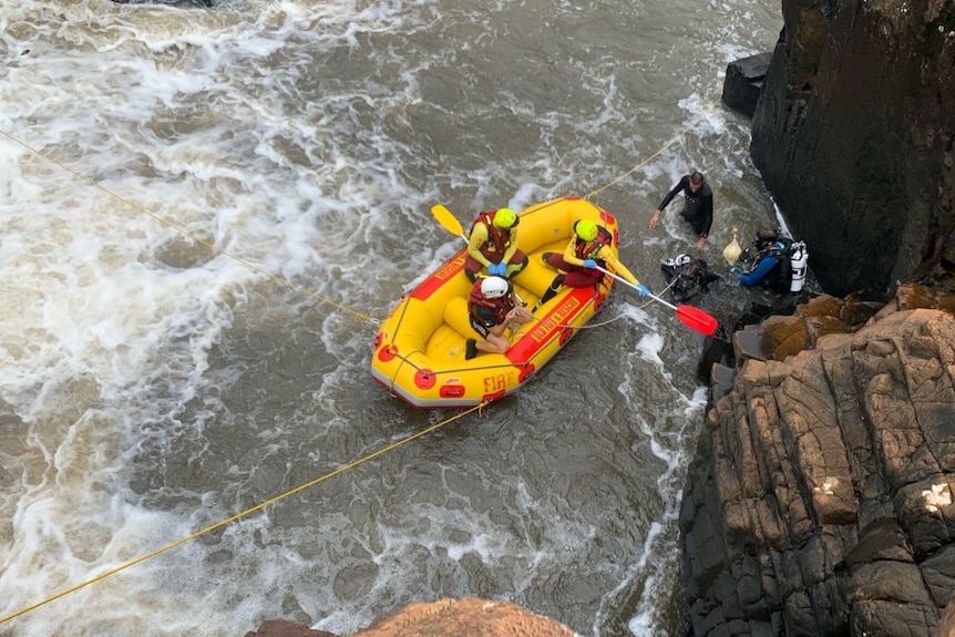 Police divers search floodwaters