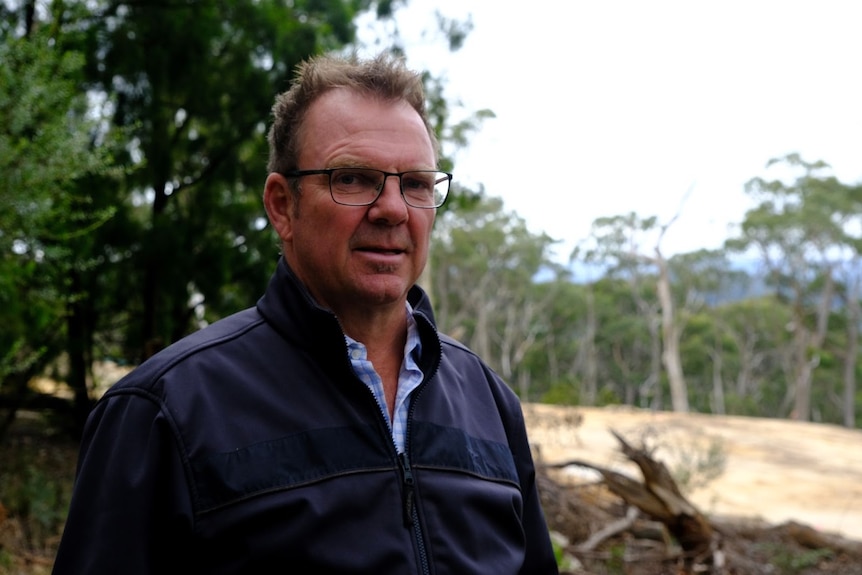 David Horbelt stands in front of cleared vegetation