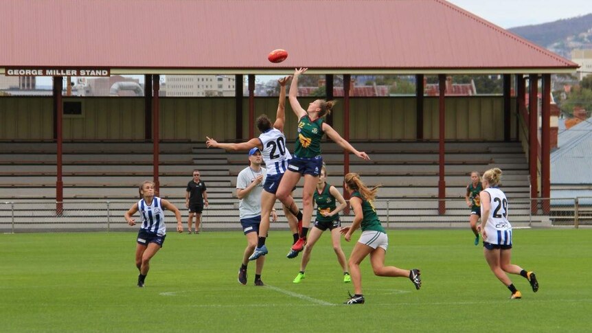 Players jump to contest the ball in a training session