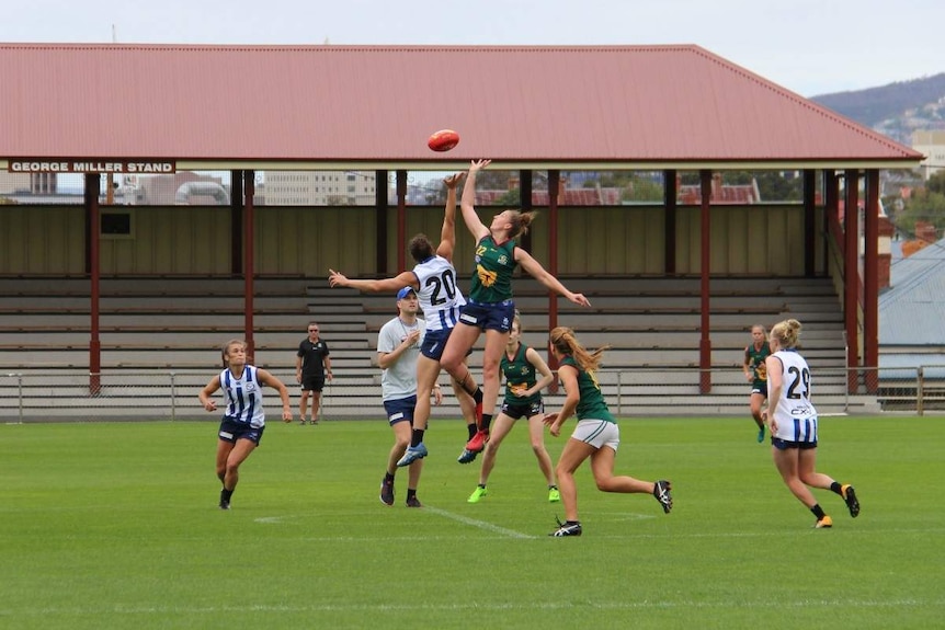 Players jump to contest the ball in a training session