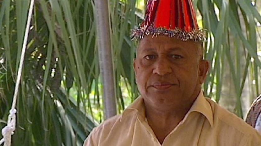 Frank Bainimarama wears a party hat