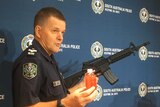 A police officer holding a gun