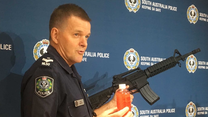 A police officer holding a gun