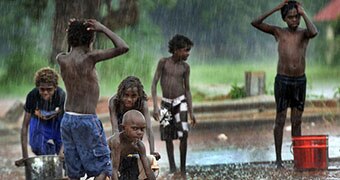 Aurukun youngsters play in the rain.