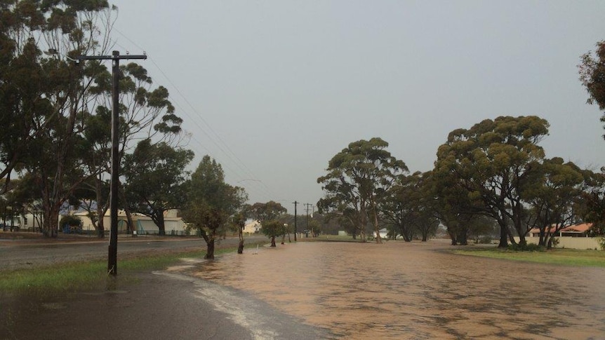 A flooded street in a small country town after significant rainfall.