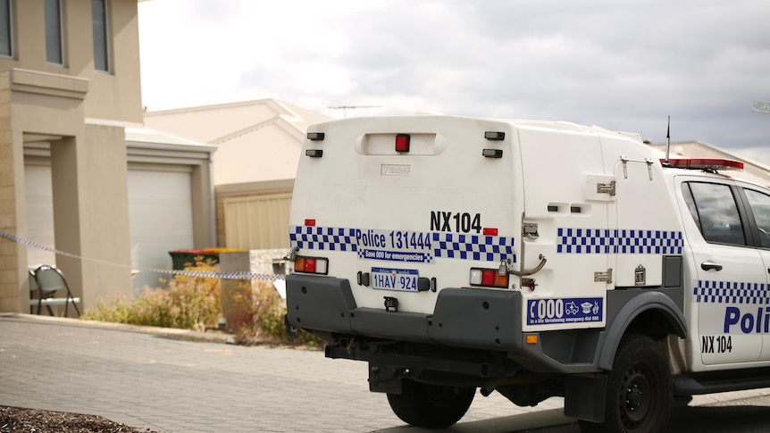 A police van parked outside a suburban home