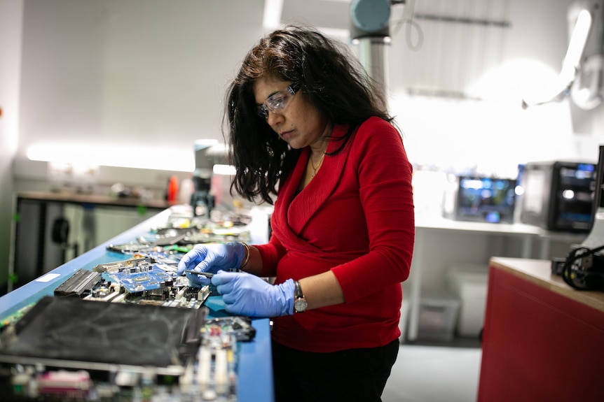  a woman looks at recycled material