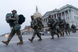 National Guard soldiers walk out of the U.S. Capitol,
