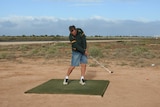 Male golfer teeing off on Nullarbor Links golf course