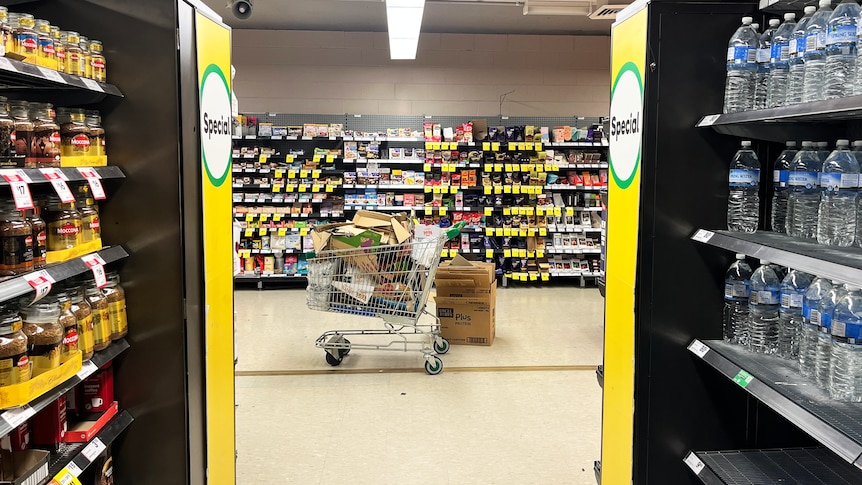 The view from a supermarket aisle, with discount stickers visible in the background.