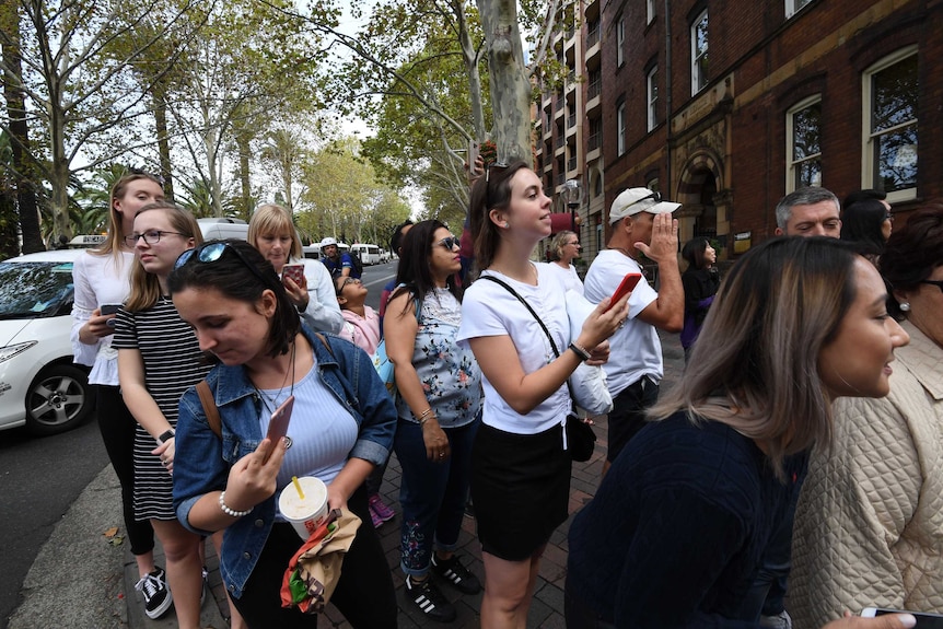 Crowds watch as former US president Barack Obama leaves CBD hotel