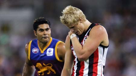 Nick Riewoldt holds his shoulder as Mal Michael looks on