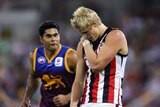 Nick Riewoldt holds his shoulder as Mal Michael looks on